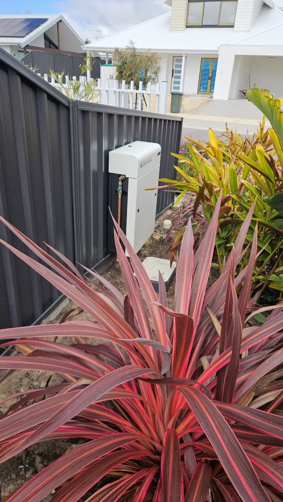Vortex Pro 3 whole-home filter in a front garden bed in a new Dunsborough estate