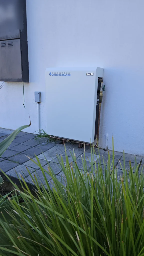 Vortex Pro 3 whole-home filter mounted on a white rendered wall