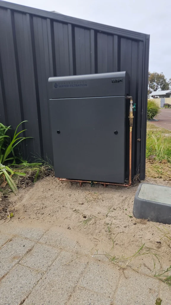Monument Vortex Pro 3 whole-home filter beside a meter pit at a Dunsborough strata home