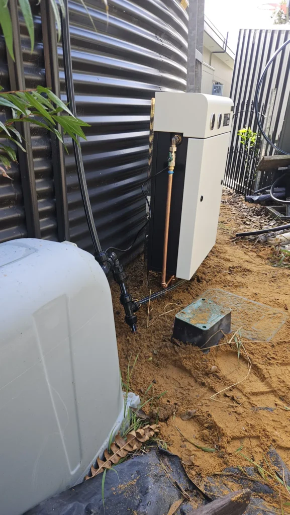 Ultra V Pro 3S whole home filter installed next to a corrugated rainwater tank